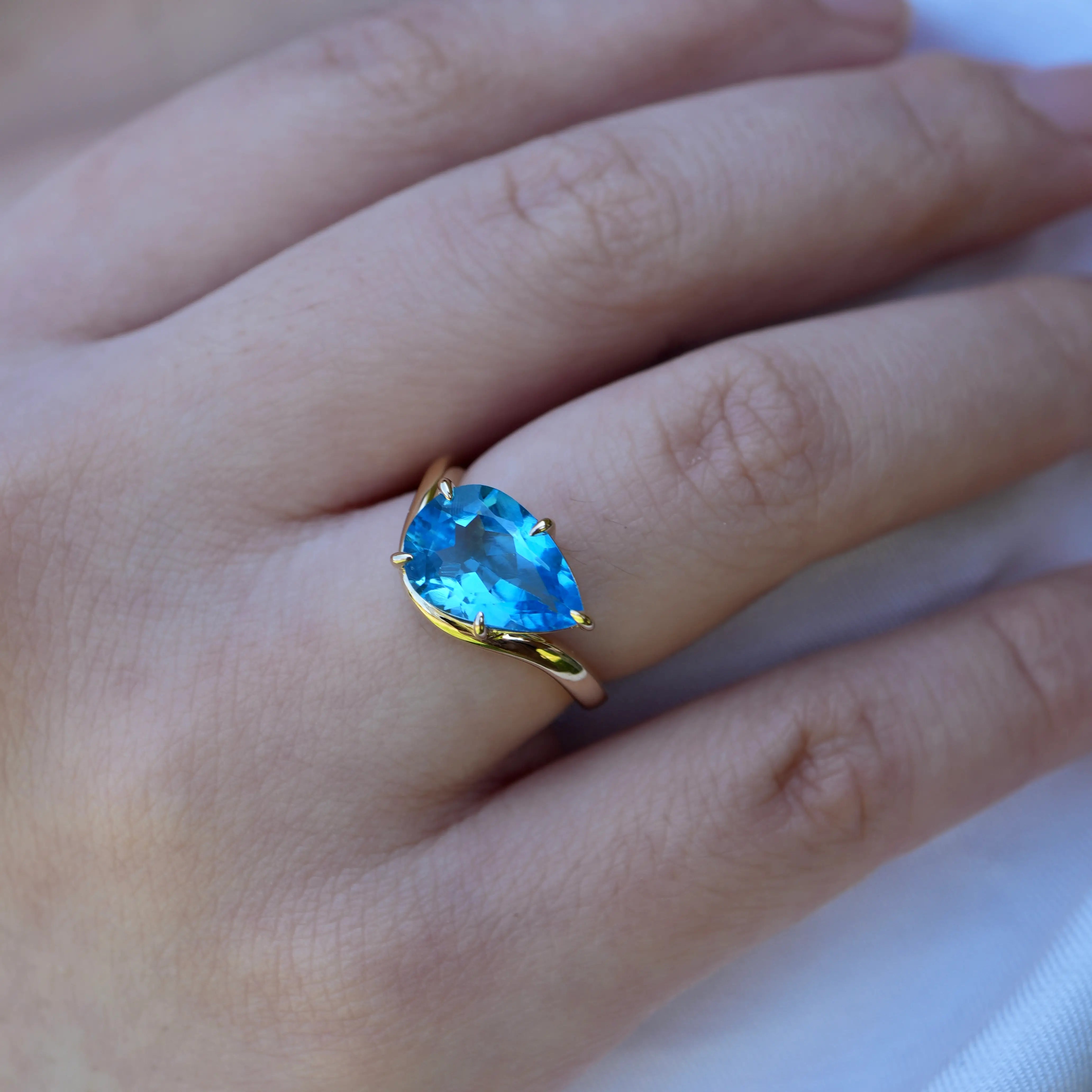 Ocean Wave Swiss Blue Natural Oval Topaz East-West Ring in 14k yellow gold