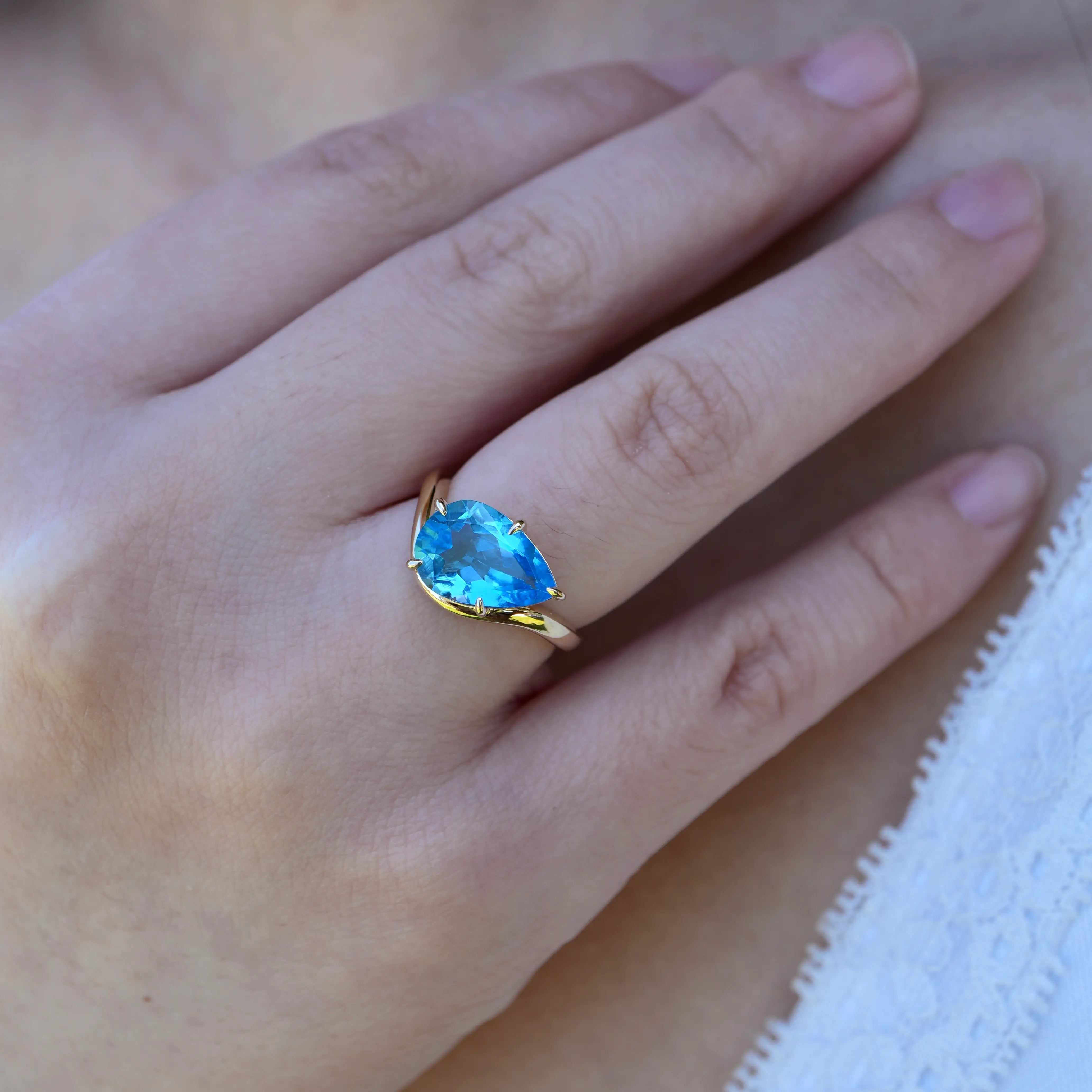 Ocean Wave Swiss Blue Natural Oval Topaz East-West Ring in 14k yellow gold 