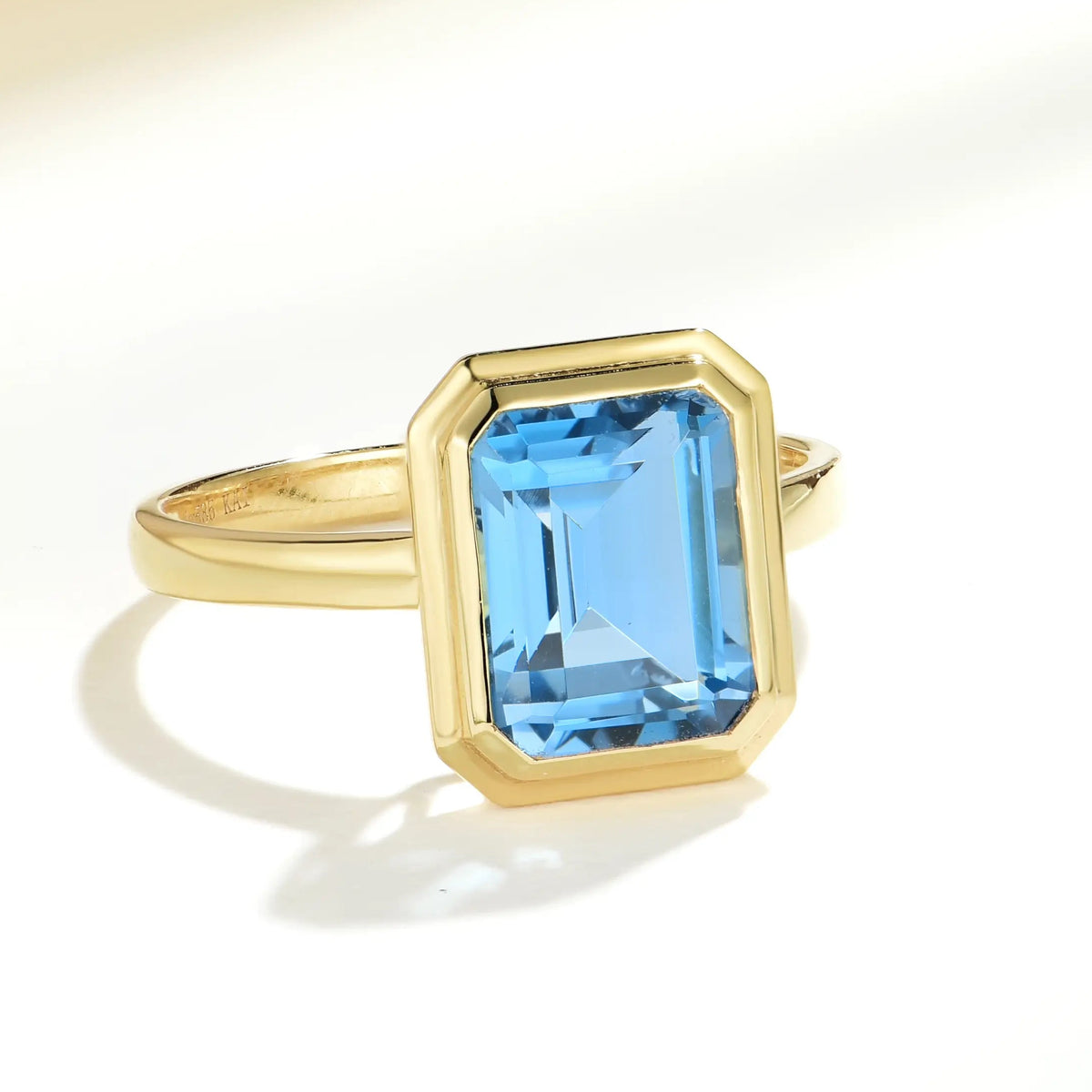 14k yellow gold emerald cut blue topaz ring